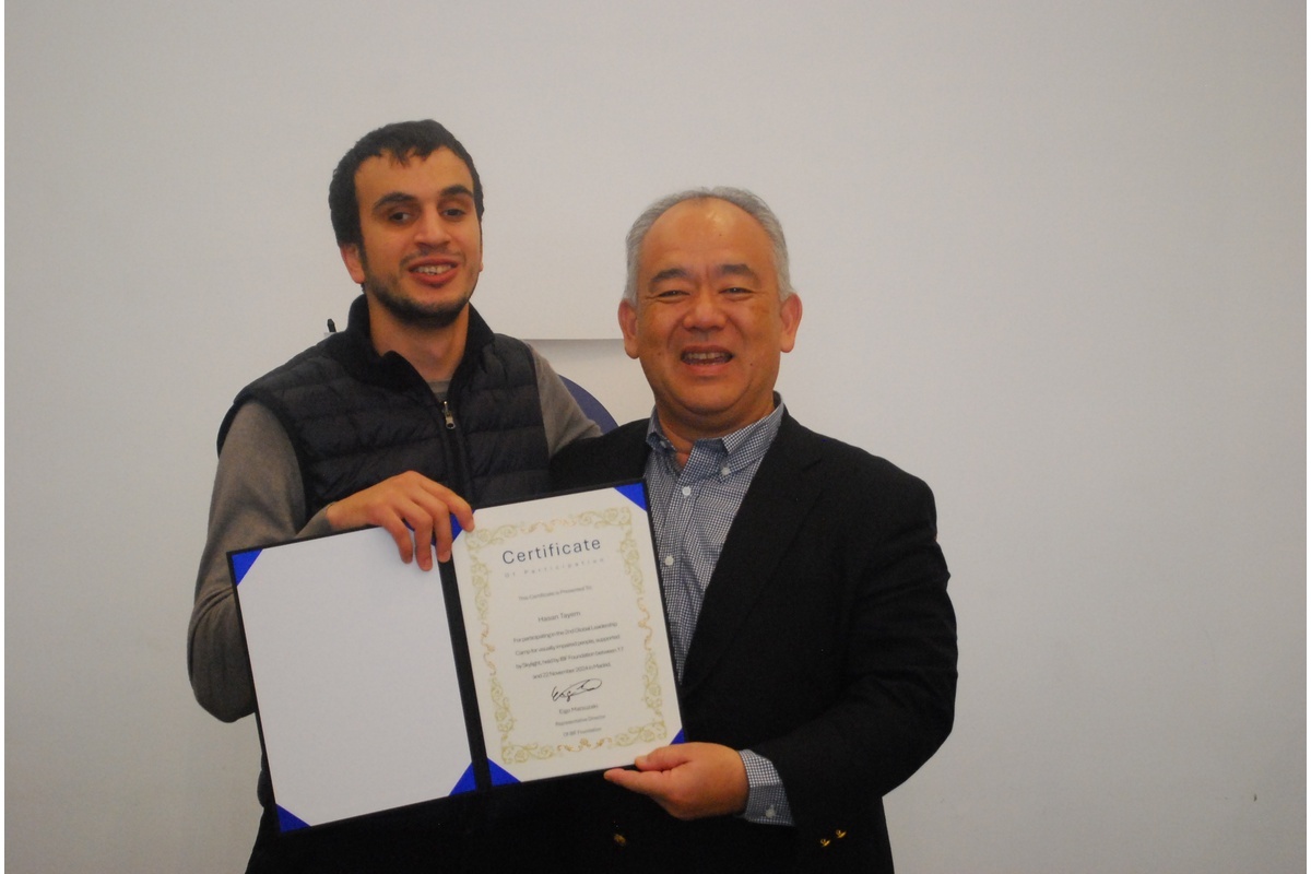 Hasan receiving a certificate at a conference